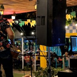 A musician playing music at a local concert setting.