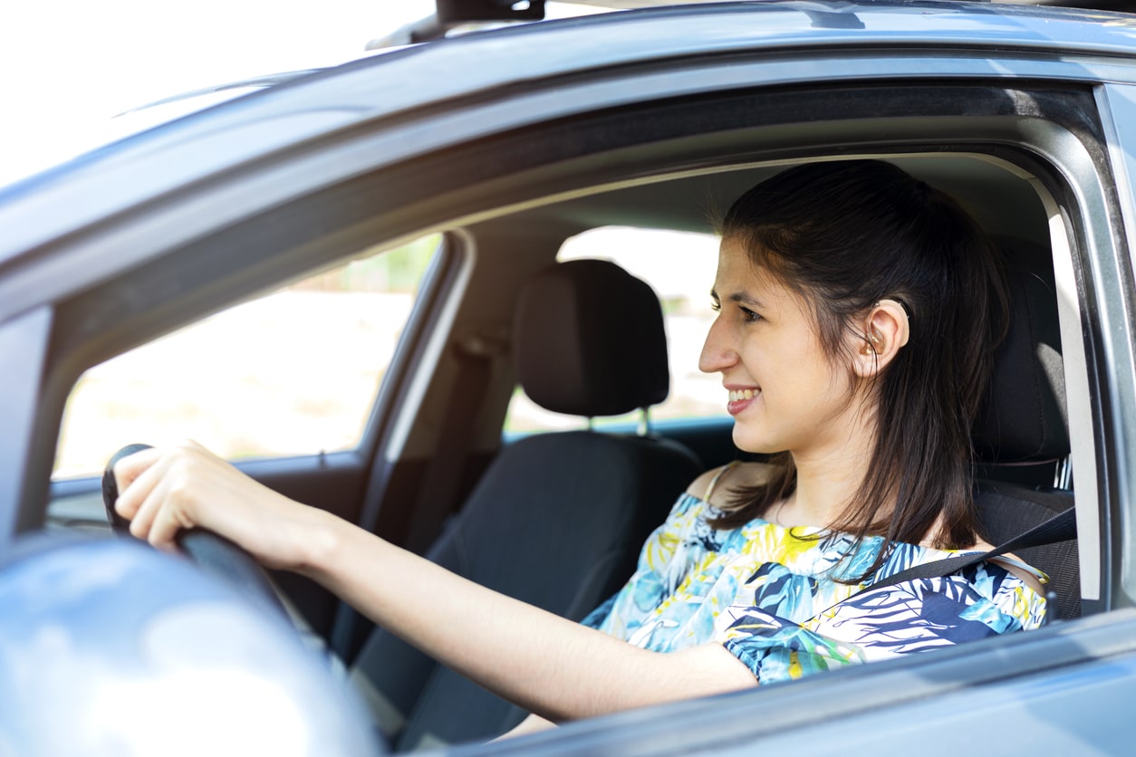Woman driving with hearing aids.