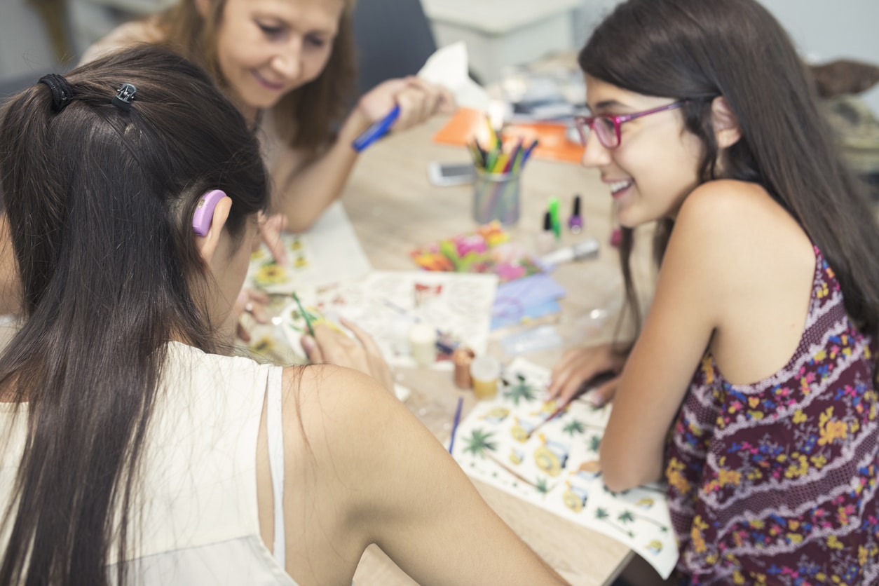 Woman with hearing loss participates in activity with friends