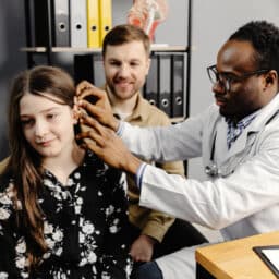 Young girl getting a new hearing aid