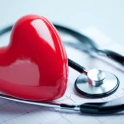 Heart model on a chart with a stethoscope.