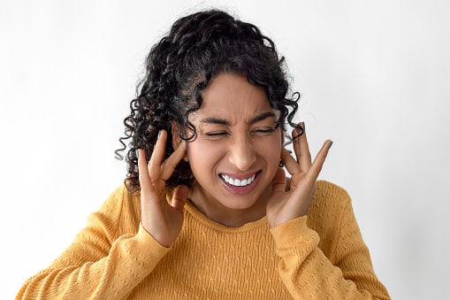 Woman plugging her ears