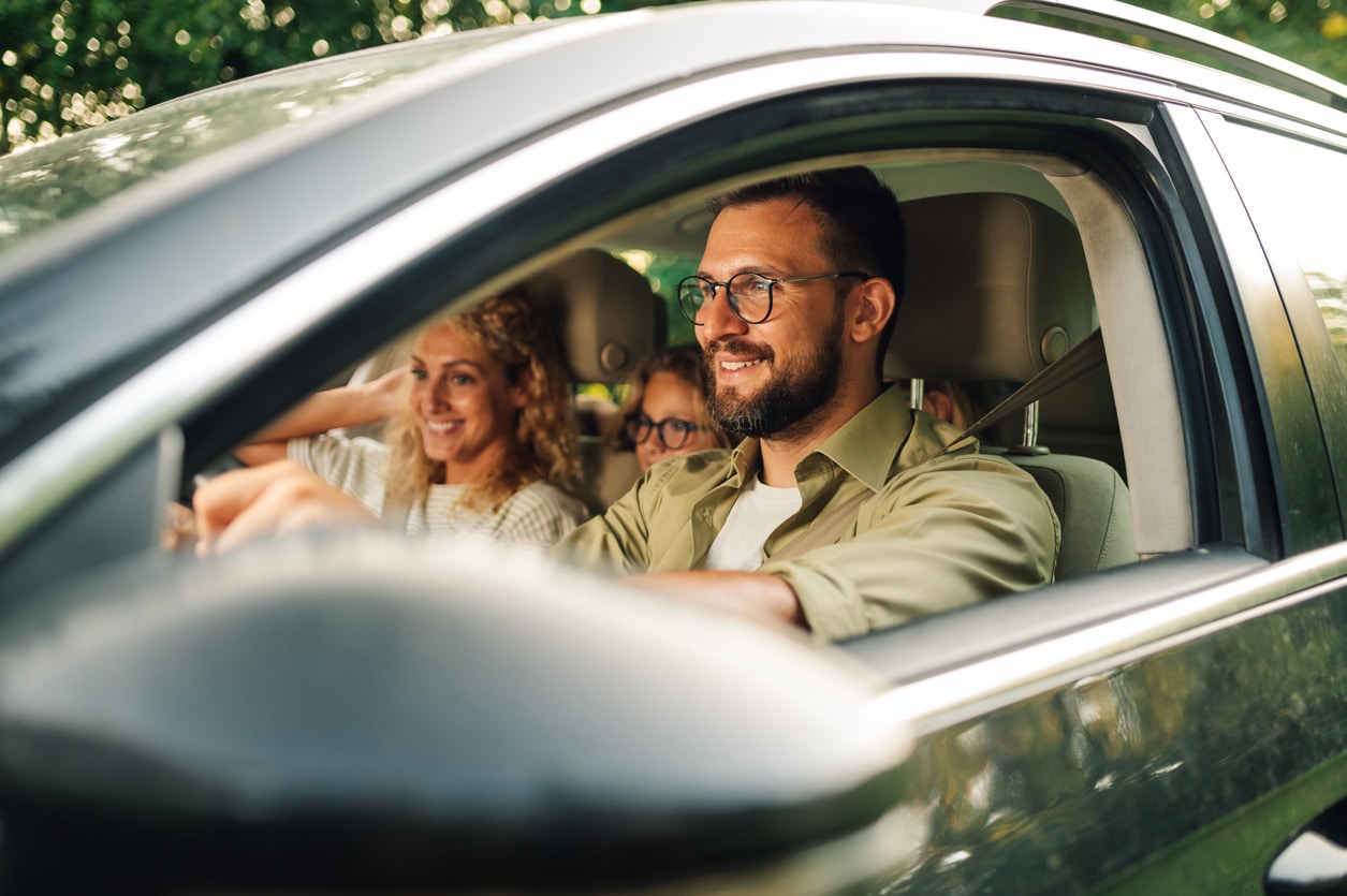 Father driving with his family in the car.