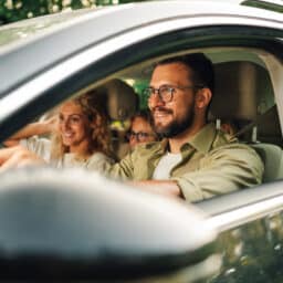 Father driving with his family in the car.