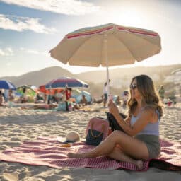 Woman relaxing on the beach under an umbrella
